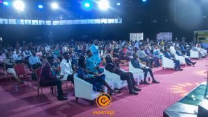 event center in lagos, cross session of crowd at event with floodlights, white couch chairs with bar stools, corporate Nigerian events,