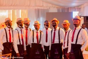 drink servers fully kitted on display, face mask, suspender shirts, tie