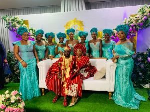 yoruba traditional wedding, couple and aso ebi girls photo pose, white couch