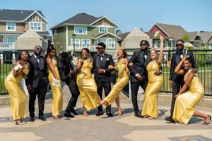 Debola and Okiki white wedding in Canada, white wedding dress gown, white suit on groom with black pant, buttonnaire, white floral bouquet with memorabilia picture of mum, elegant smile, bridal make up, wrist watch, fun wedding picture, wedding day photoshoot