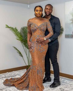 Debola and Okiki white wedding in Canada, white wedding dress gown, white suit on groom with black pant, buttonnaire, white floral bouquet with memorabilia picture of mum, elegant smile, bridal make up, wrist watch, beaded after party bridal dress, couple look