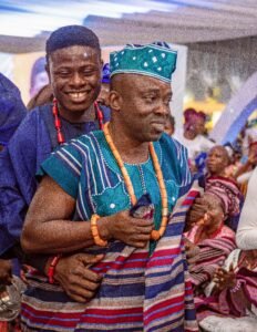 Nigerian couple yoruba traditional wedding photoshoot, blue agbada, aso oke, gele, attire and outfit. Yoruba fila, rich ondo state culture for traditional wedding. Couple backed by parent