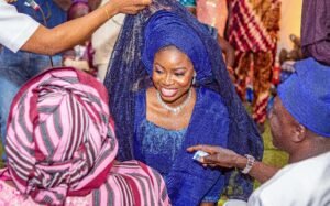 Nigerian couple yoruba traditional wedding photoshoot, blue agbada, aso oke, gele, attire and outfit. Yoruba fila, rich ondo state culture for traditional wedding. unveiling of the bride