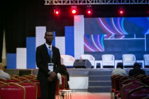 The WorkPlace Outlook conference planning in lagos, Nigeria white bucket chairs with stools, panel session, screen, corporate event stage set up, best corporate event decoration