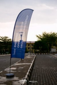The WorkPlace Outlook conference planning in lagos, white bucket chairs with stools, panel session, screen, corporate event stage set up, feather banner, best experiential event in Nigeria