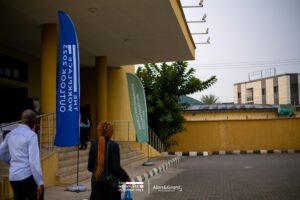 The WorkPlace Outlook conference planning in lagos, white bucket chairs with stools, panel session, screen, corporate event stage set up, feather banner, outdoor advertising, conference planner in Lagos, Nigeria