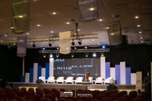 The WorkPlace Outlook conference planning in lagos, white bucket chairs with stools, panel session, screen, corporate event stage set up