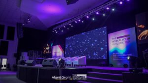 Eventigo The workplace outlook conference, stage design with LED screen, stage props, banners, lounges, white couch, side stools, corporate event planner in Lagos
