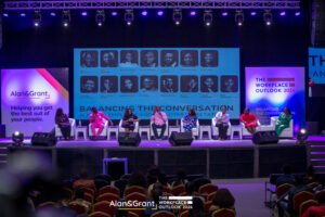 Eventigo The workplace outlook conference, stage design with LED screen, stage props, banners, lounges, white couch, side stools event planner with lighting for corporate event