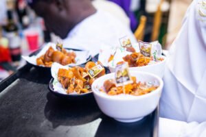 food menu for nigerian birthday, finger food, asun, peppered ponmo, white plate served, wedding meal